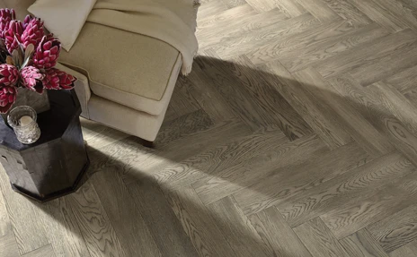 Herringbone hardwood floor with dark red/pink flowers 