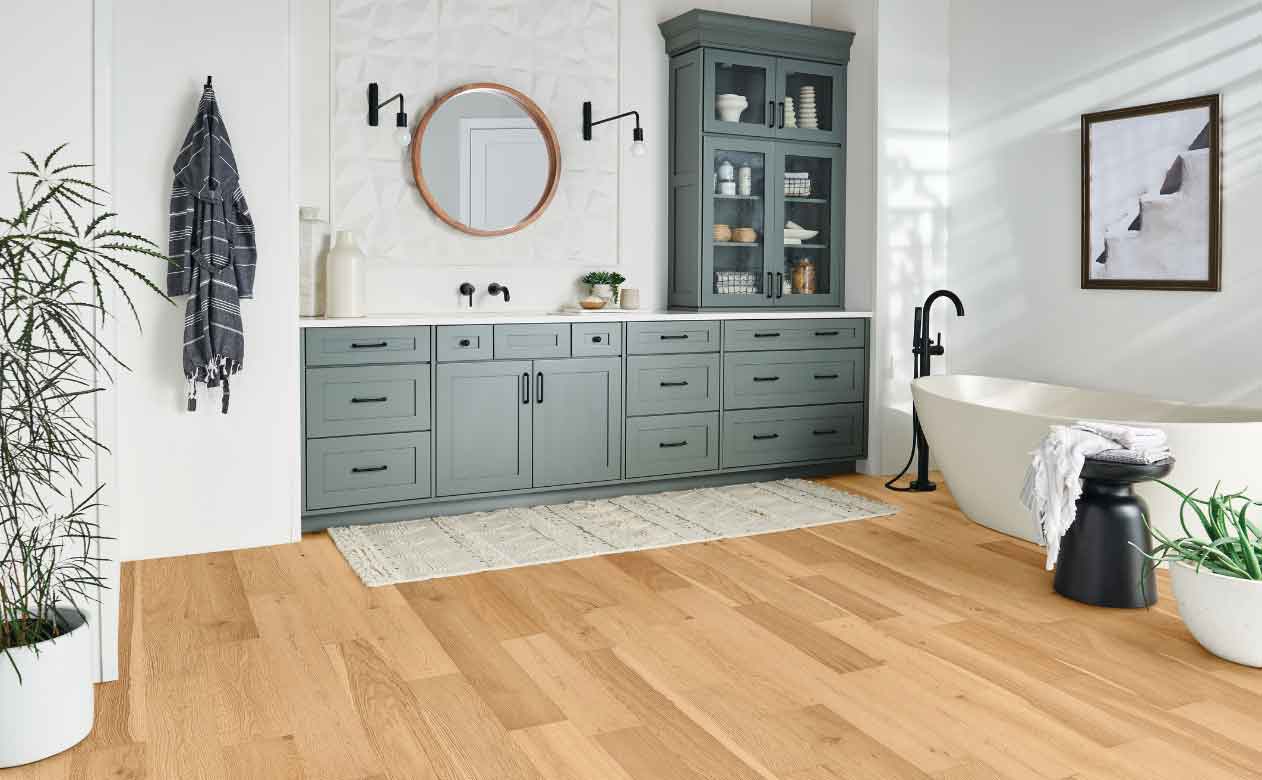 Hardwood floor in bathroom, light hardwood, green cabinets